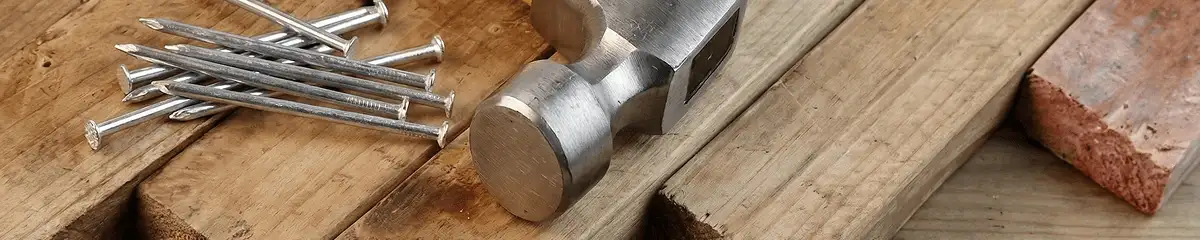 Hammer and nails on hardwood flooring boards in Savannah, GA