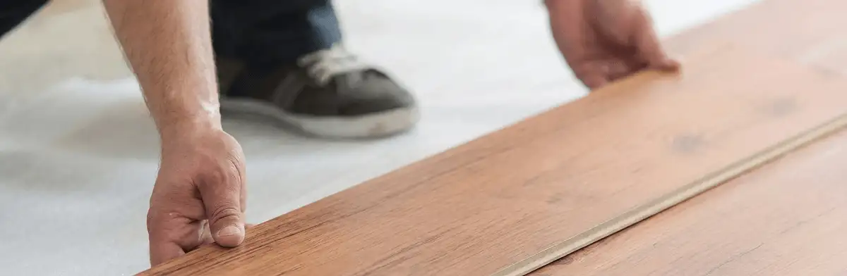 A professional installing laminate flooring in Savannah, GA